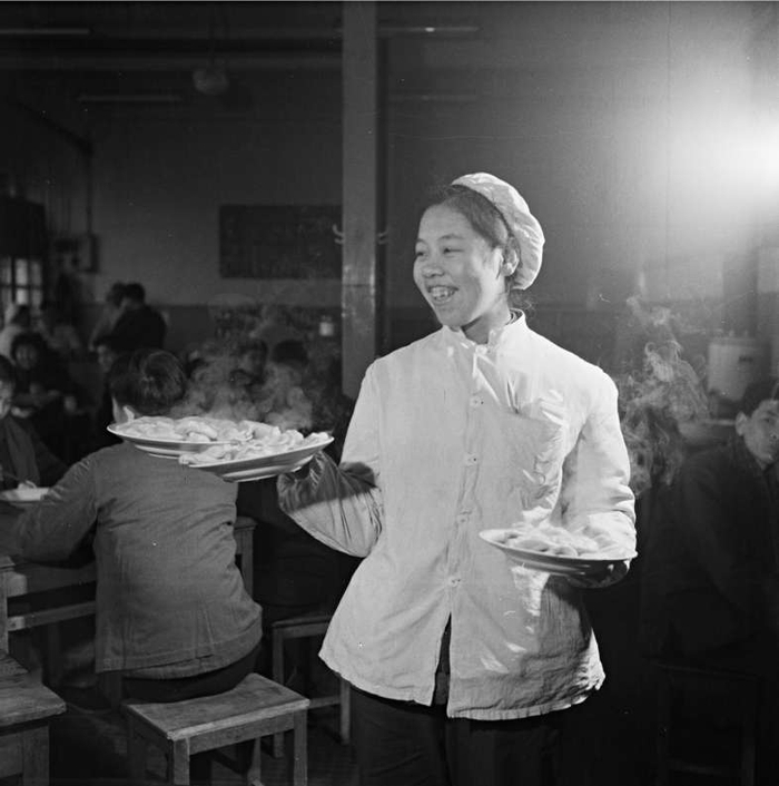 1964年大年夜，饭馆服务员为顾客端上热气腾腾的水饺。高宏摄