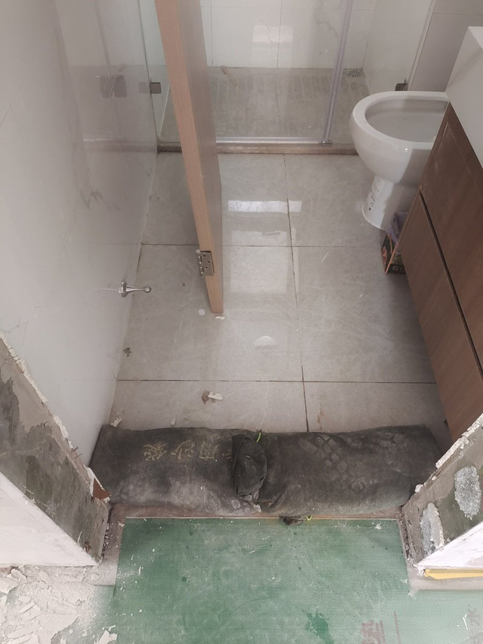 △一位二层住户家中，卫生间淋浴室的排水口反水严重，甚至需要用沙袋挡水。