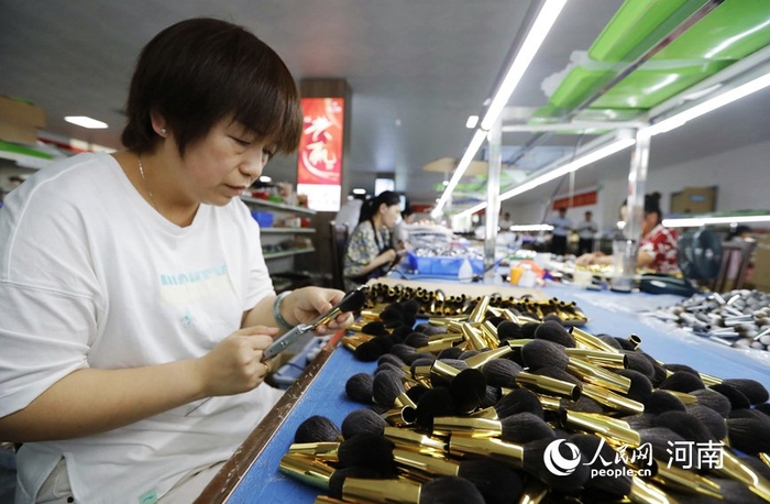 村民在在标准化车间工作。人民网 霍亚平摄