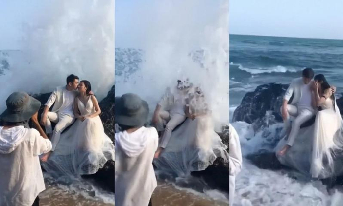 新人坐礁石上拍婚纱照，大浪冲下双双变成“落汤鸡”/图源：网络