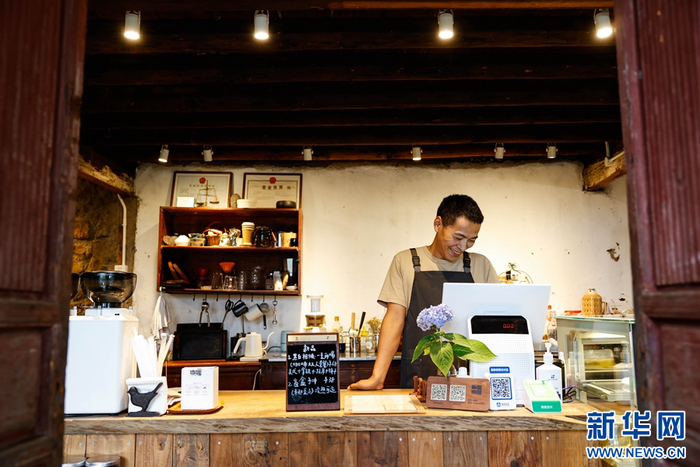 邱佳在咖啡馆中为顾客点单（摄于9月19日）。新华网 赵普凡 摄
