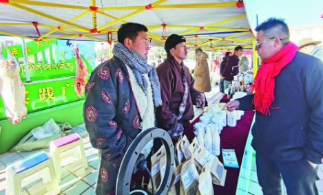 项青本和旦达尔向顾客介绍自家特色产品。谭梅/摄