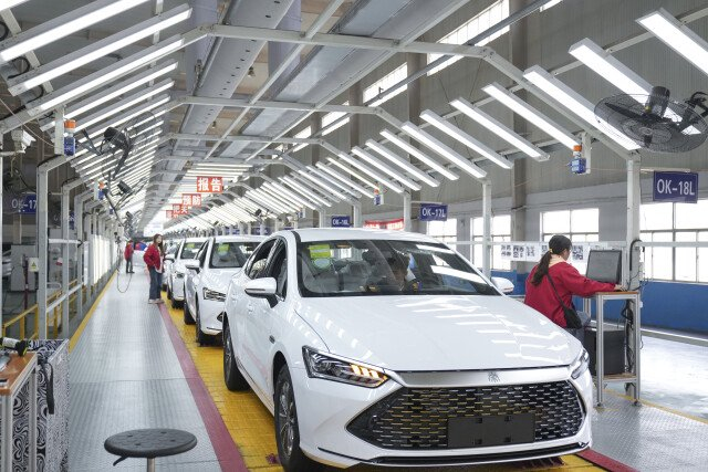 (比亚迪长沙基地总装车间,工人在新能源汽车生产线上忙碌.