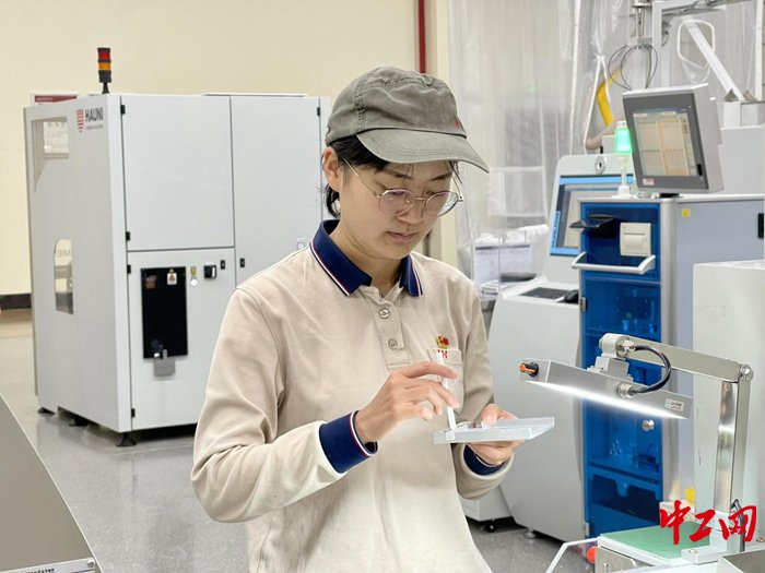 竞赛中女工用量盘手感圆周。 汪子菁 摄