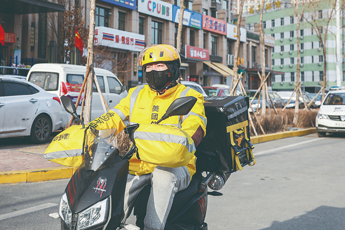 外卖小哥正在为消费者运送取暖商品。 李依南 摄