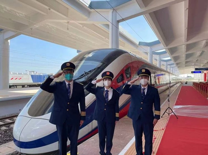 2021年12月3日中老铁路开通之时，宋赛（右一）与同事在铁路上工作