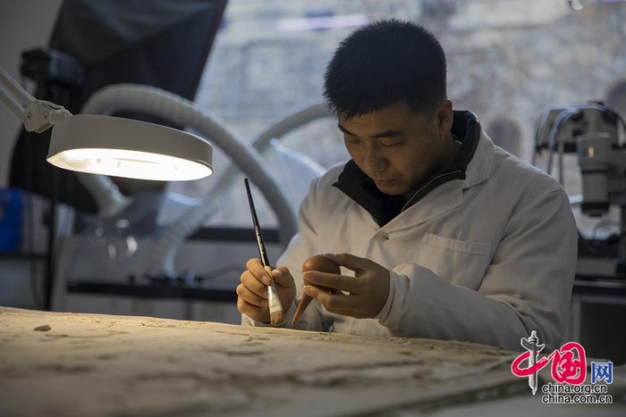云冈研究院修复室内，修复员正在对文物“精心打磨”。中国网记者 马旷／摄