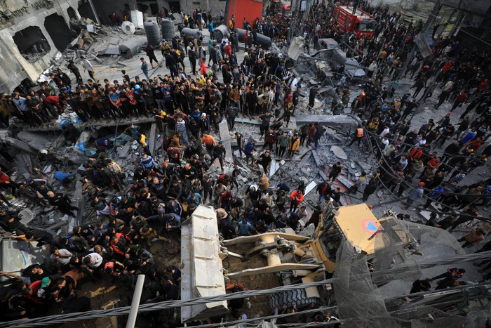 ▲12月20日，加沙南部城市拉法民众在以军空袭后开展救援。图据新华社