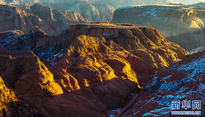 12月24日，靖边县龙洲波浪谷丹霞景区的色彩随着光影的变化而变换成不同的色块，奇妙无比。