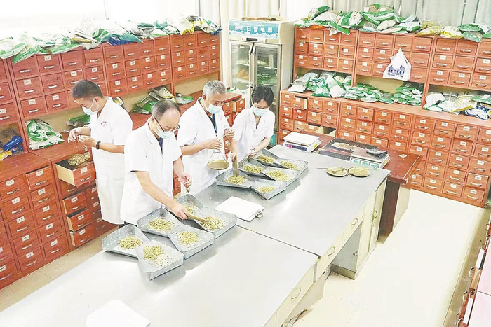 怀宁县中医医院中药房医生在为患者配发中药材。本报通讯员 檀志扬 摄