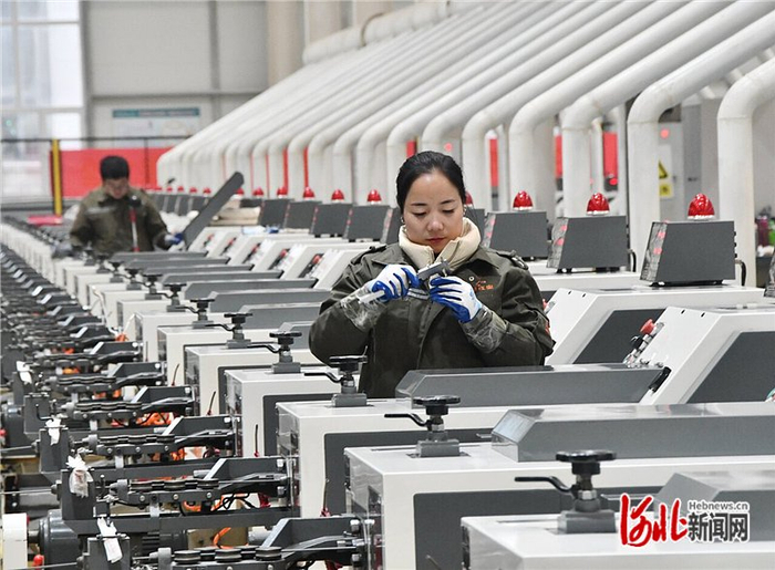 2023年2月14日，在河北永年工业园区的河北喜力德五金制造有限公司，工人在数字化智能生产车间测量产品。 胡高雷摄