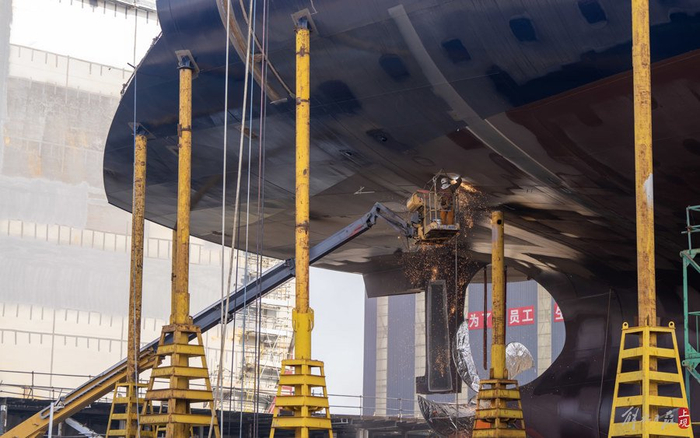 船体尾部区域碳刨修割。本报记者 孟雨涵 摄