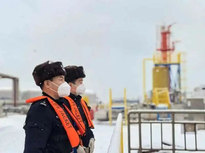 移民管理警察顶风冒雪，监护出入境船舶安全高效通关。（陈超 摄）