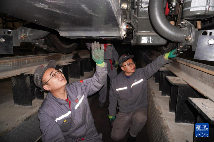 69691月29日,中车兰州机车有限公司工人在检查机车底部.