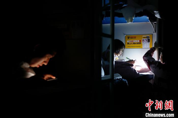 夜晚，孩子在1462次列车硬卧车厢内学习。中新网记者 殷立勤 摄