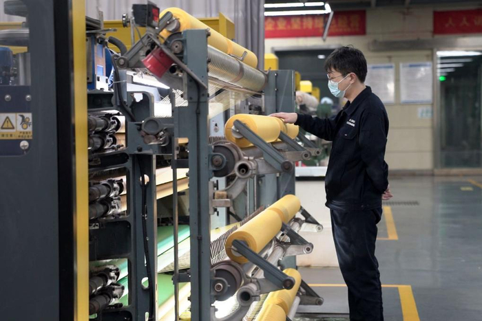 在河北南冠科技有限公司生产车间，工作人员查看设备运行。新华社记者岳文婷 摄