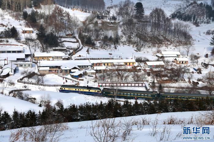 4349次列车经过沿线被白雪覆盖的小村庄。 新华网发 曲晓曦摄