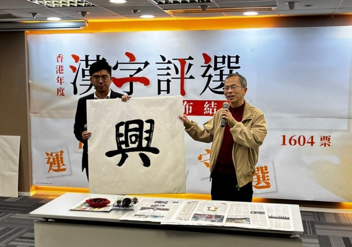 主办方举起“兴”字书法作品（《星岛日报》）