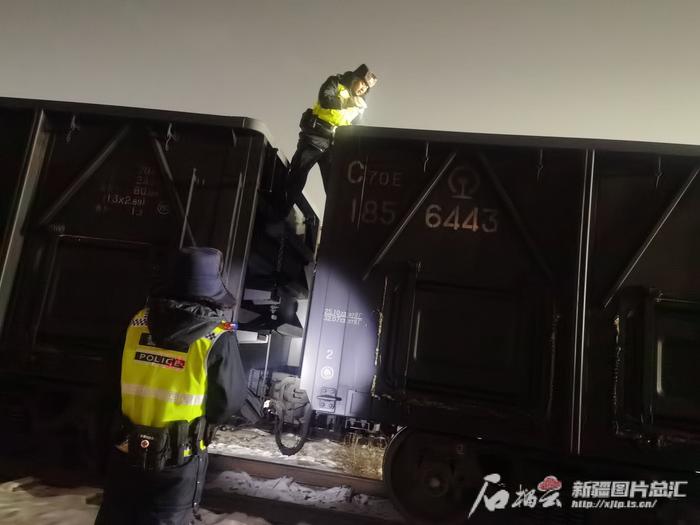 2月8日凌晨3时，齐浩浩和同事徐乾龙在铁路准轨执勤现场，查验出境的敞车。天山网-新疆日报记者 白素君摄