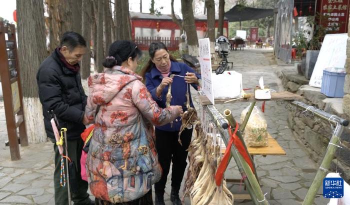   游客在村里选购腊味。新华社记者龚联康 摄