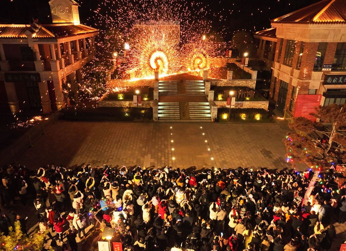 2月11日，在湖南省衡阳市南岳区祝融小镇，人们观看非遗打铁花表演（无人机照片）。新华社发（曹正平摄）
