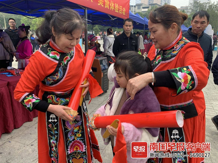 ▲“宜州渔鼓”的传承人在教小女孩打渔鼓。