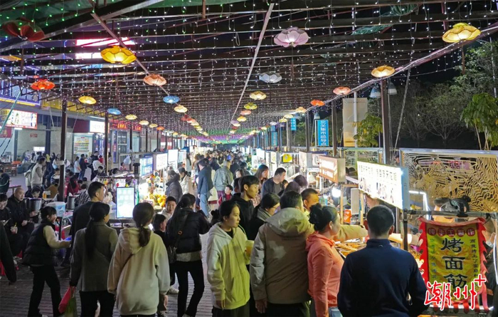 北堤夜市里，游客品尝特色小食