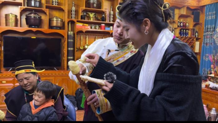 图为工布藏族民众在新年期间享用藏式奶酪“结达”。中新社记者让宝奎摄