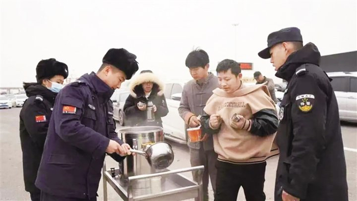 　　工作人员为滞留群众送上热水。（来源：新甘肃客户端微信公众号）