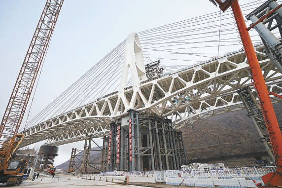 国道109新线高速建设全面复工复产，完成转体的安家庄特大桥开始进行桥面铺装。 本报记者 程功摄