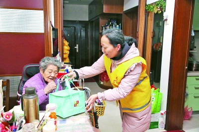     江苏省常州市钟楼区荷花池街道西新桥一村社区的网格员上门为独居老人送晚餐。新华社发