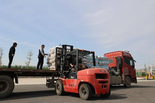 图为在阿拉山口边民互市一级市场展销中心，工人正在卸货。（文亚辉 摄）