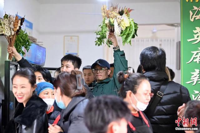3月14日，甘肃天水，游客手举挑选的麻辣烫食材“蔬菜花束”。九美旦增 摄