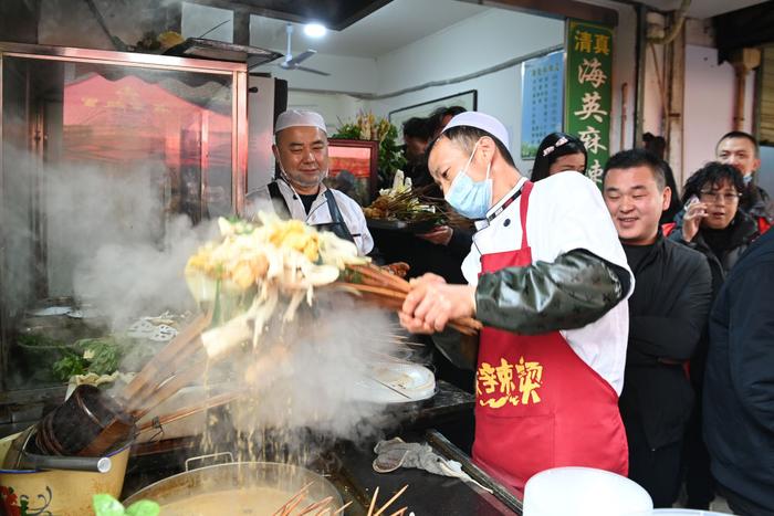   3月16日，在天水市秦州区的天水名优小吃城一麻辣烫店，商家为游客加工麻辣烫。新华社记者 范培珅 摄