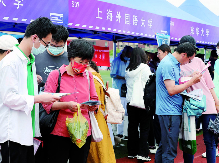     考生和家长在咨询会现场了解高校招生信息     新华社发