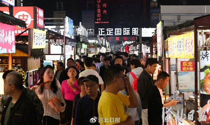 4月16日，正定小商品夜市人头攒动，游客在购买各色美食。河北日报记者 史晟全摄