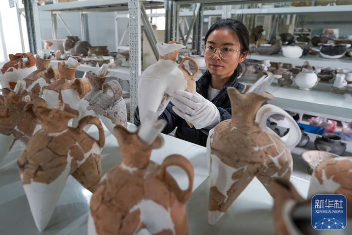↑南京博物院寺墩考古工作站的工作人员在库房内整理文物（2024年4月8日摄）。新华社记者 李博 摄