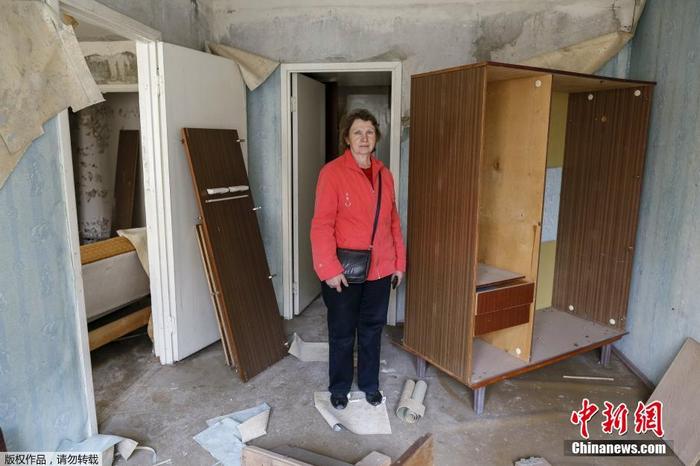 图为切尔诺贝利事故受害者Valentina Yermakova来到自己曾经的家中，周围是在事故中遭毁的家具。