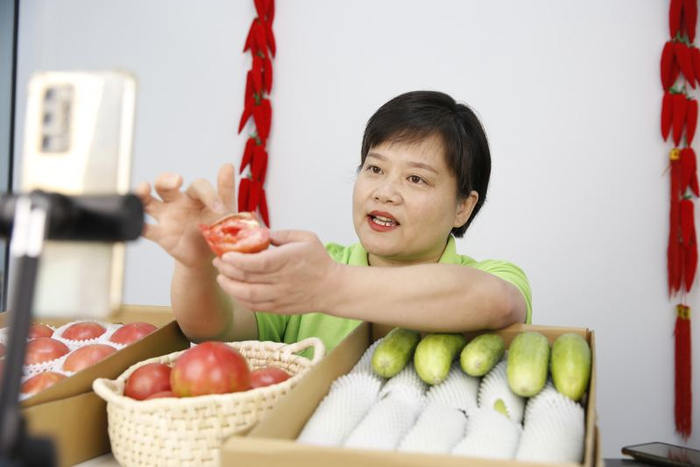 王丹正在直播带货，推介西红柿和黄瓜。通讯员 马平川 摄
