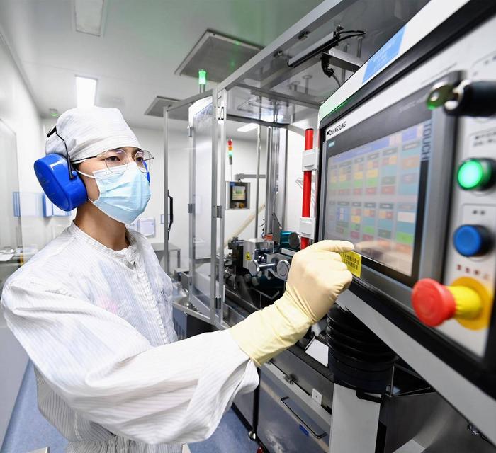 人福普克药业(武汉)有限公司无菌生产车间内，工人正在操作制药。