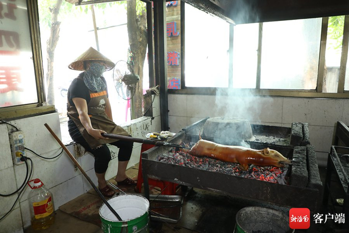  工作人员正在烤制乳猪。记者 郑光平 摄