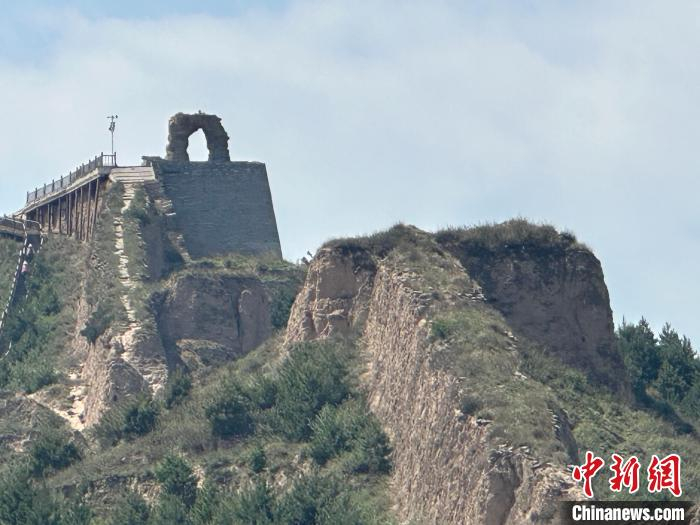 在山西山阴县的广武明长城脚下,来自上海的游客宋先生正拿着手机拍摄