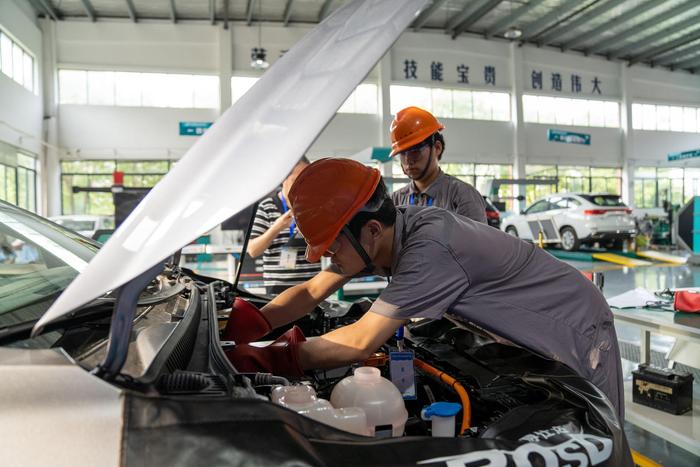 ↑6月1日，2024年合肥市中等职业学校技能大赛中，选手们在进行新能源汽车维修比赛。图据视觉中国