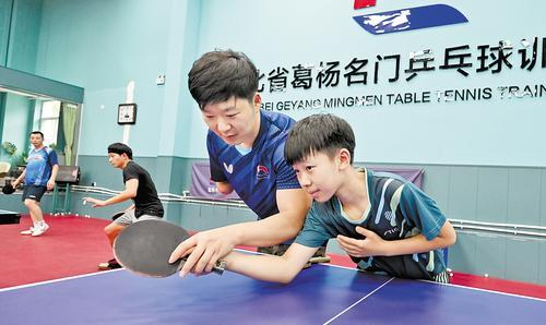     6月6日，葛杨（右二）在位于河北保定师范附属学校内的河北省葛杨名门乒乓球训练基地指导运动员训练。 河北日报记者 王伟宏摄