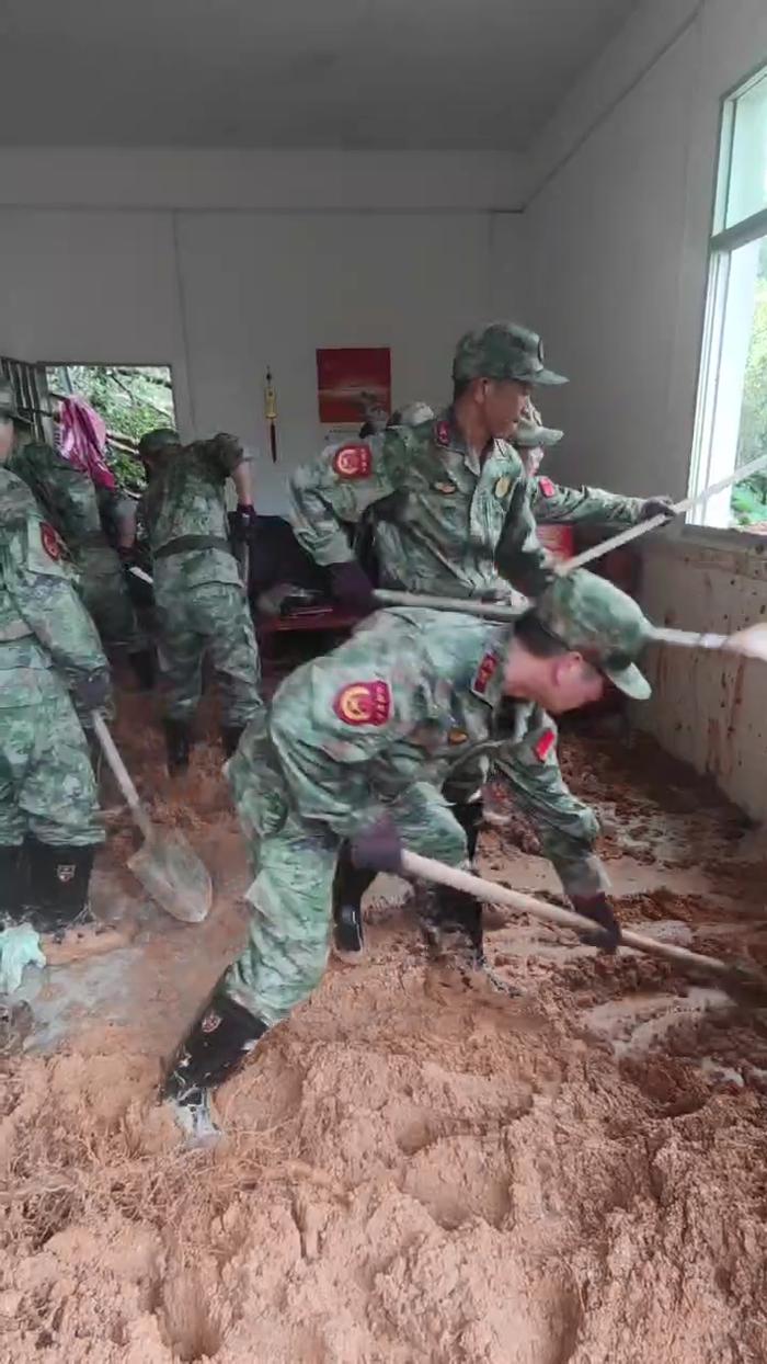　　▲上杭县民兵清除冲入房屋的淤泥。