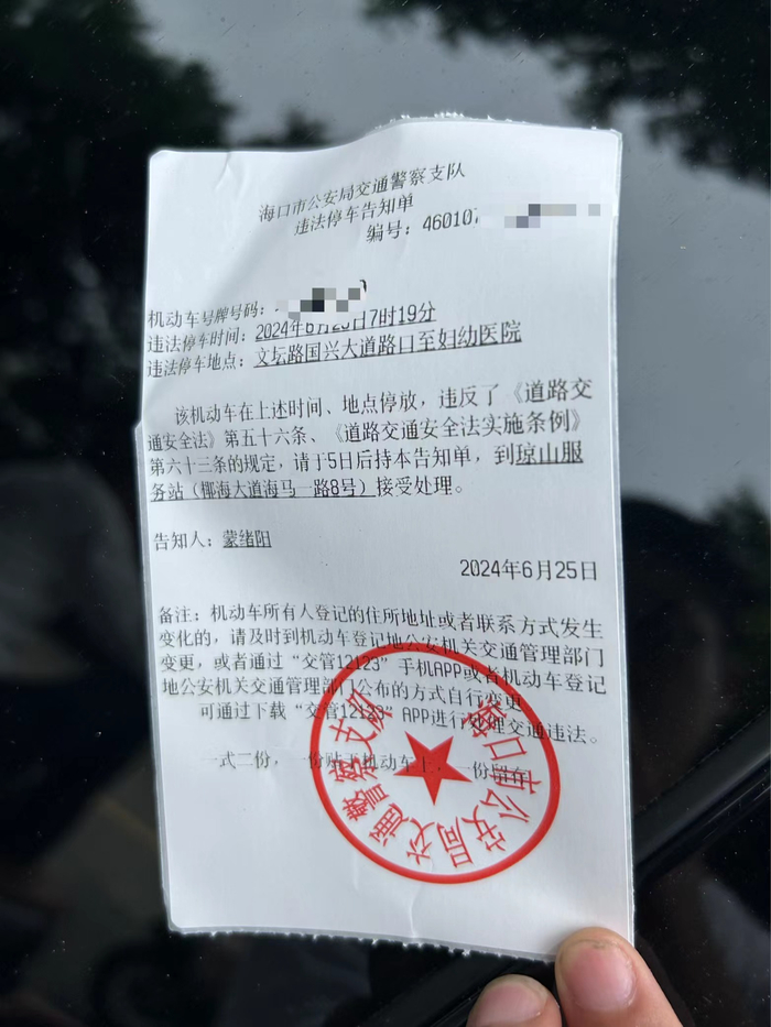 市民到海口市妇幼保健院看病，在划线车位停车被贴罚单。记者 袁玉龙 摄