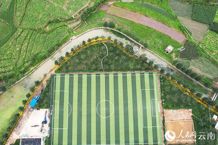 村里的足球场与农田融为一体。人民网记者 程浩摄
