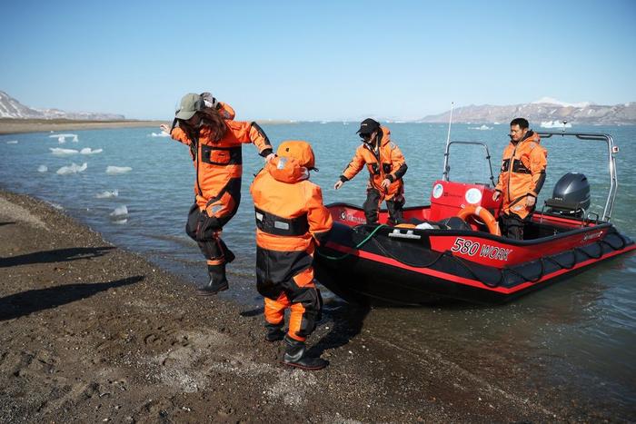 6月22日，在挪威斯瓦尔巴群岛，黄河站科考队员搭乘小艇前往冰川采样。（赵丁喆 摄）