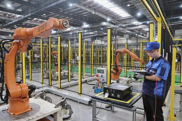 上海新时达机器人有限公司机器人测试区，工作人员正在调试测试机器人。赖鑫琳摄