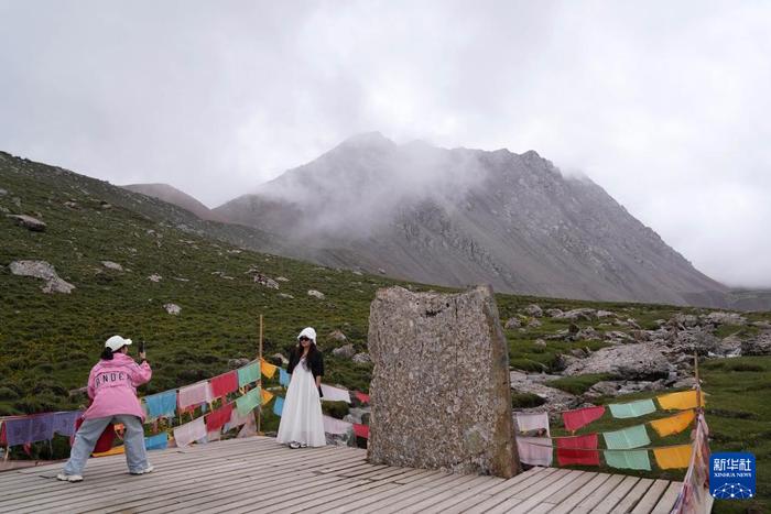 7月13日，游客在巴尔斯雪山景区拍照。新华社记者 马宁 摄